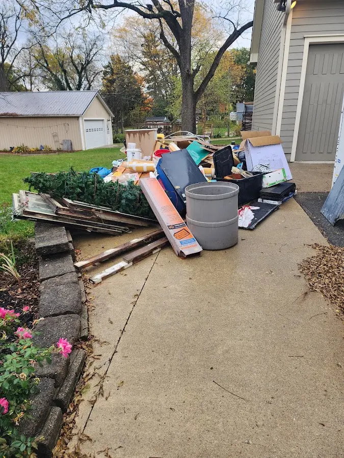 Dumpster being loaded with debris for Residential Dumpster Rental in Pearl River